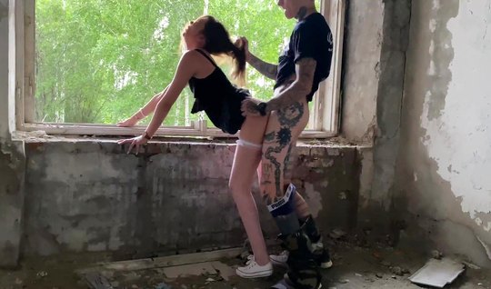 A Russian couple in an abandoned building stood in a pose an...